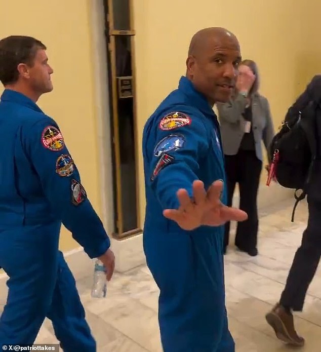 Conspiracy theorist confronts Artemis II astronauts on Capitol Hill, accusing them of faking spaceflight.